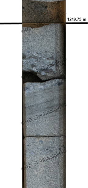 A close-up, vertical view of a geological core sample inside a vertical channel. The sample is divided by a prominent horizontal black line near the top, labeled on the right with the depth marker "1249.75 m". Above this line, a small portion of dark, highly fragmented gravel-like rock is visible. Below the line, the core sample consists of several larger, intact cylindrical blocks of textured grey sedimentary rock. The rock sections show internal variations, including a layer with distinct pebble-like clasts, a middle section with fine horizontal sedimentary bedding bands, and a lower speckled grey section containing embedded dark fragments. A semi-transparent watermark text reading "© R2V Technologies" is tiled diagonally across the length of the sample.